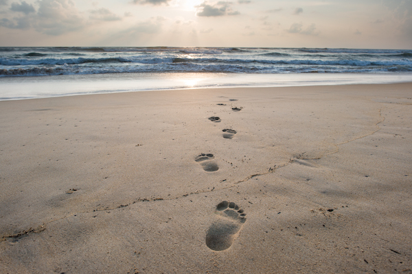 Footsteps On Sandy Beach